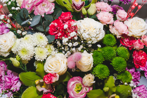 Different types of white, pink roses, and other flowers in floral arrangement. Beautiful fragrant bouquet. Floristry and floral design concept. Floral texture close-up.