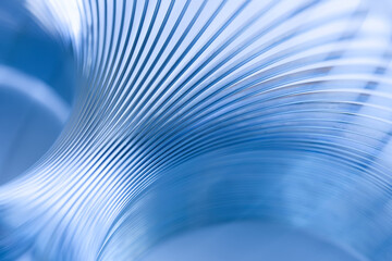 Close-up of flowing metal curves creating a dynamic blue abstract texture with copy space. Modern technological backdrop for innovation, research, industry or corporate slides. Photo