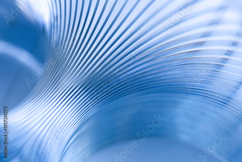 Close-up of flowing metal curves creating a dynamic blue abstract texture with copy space. Modern technological backdrop for innovation, research, industry or corporate slides. Photo