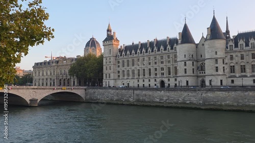 Seine River Cruise Boat Passing Historic Buildings at Sunset in Paris France
