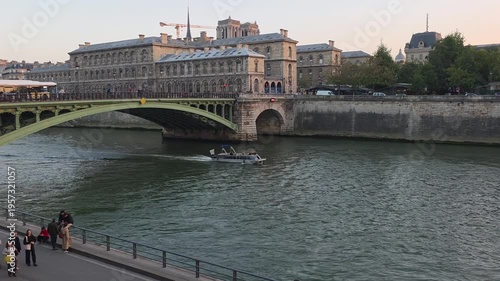 Seine River Cruise Boat Passing Historic Buildings at Sunset in Paris France