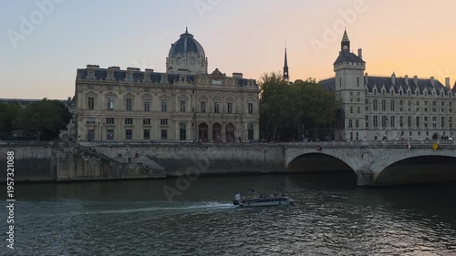 Seine River Cruise Boat Passing Historic Buildings at Sunset in Paris France