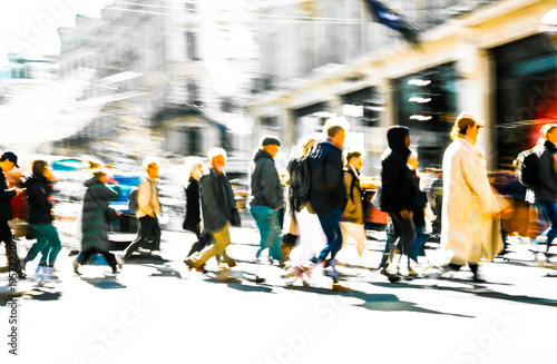 Postmodernism style, artistic motion of people with shopping bags crossing Oxford Circus junction at sunny day. London
