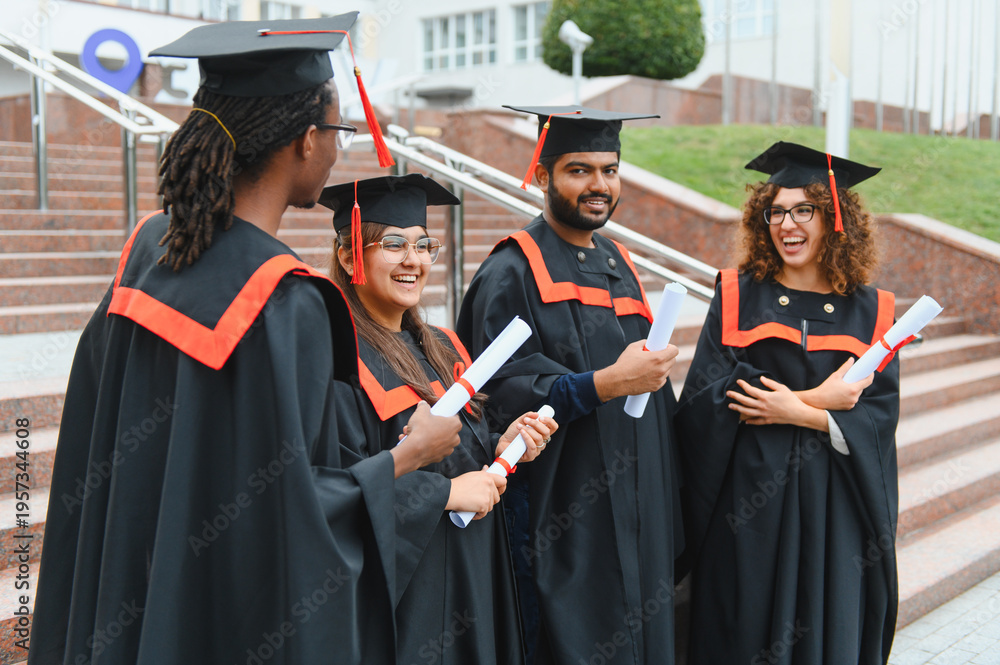 Obraz premium Diverse graduating students celebrating university success concept