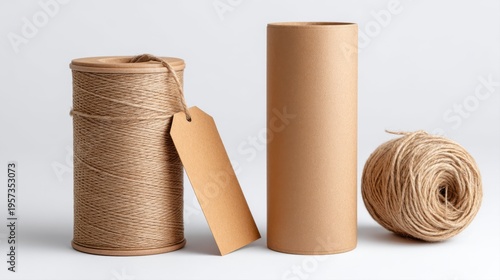 Spool of twine, cardboard tube, and ball of twine on a white background string rope