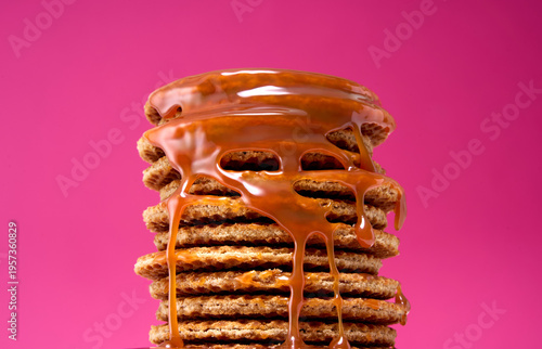 Waffle Stack with Caramel Sauce Dripping on Pink Background