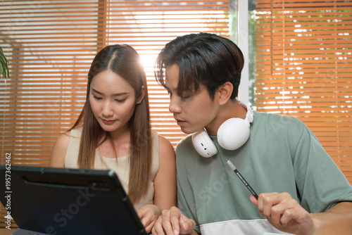 A young Asian couple spend time together at home
