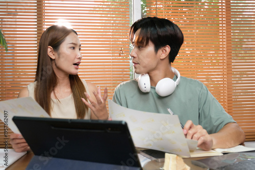 A young Asian couple spend time together at home