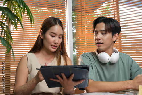 A young Asian couple spend time together at home