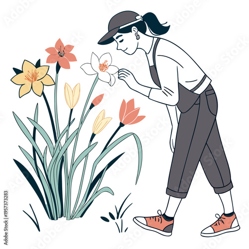 Woman smelling white flower in garden overalls flowers