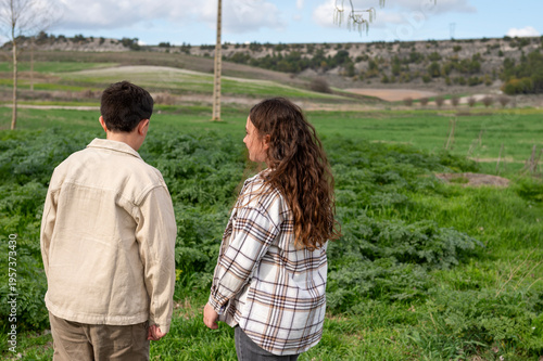 Children exploring nature in green countryside landscape