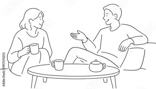 A couple sitting on the floor and talking over coffee