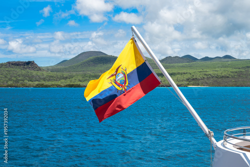 National Flag of Ecuador on Flagpole of Cruise Ship in the Galapagos Islands in Front of Mountain Background