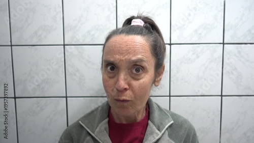 Kas, Turkey - 9 of February 2026: 4K Woman making funny faces in the mirrore and xamining her eye
