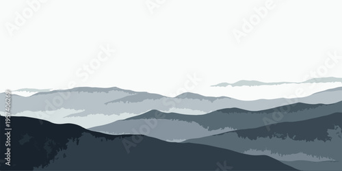 A scenic morning landscape featuring misty mountains and clouds at sunrise with a silhouette of hills over a deep blue forest valley in the fog.
