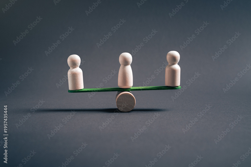 Obraz premium Collective balance and organizational stability concept with three wooden figures