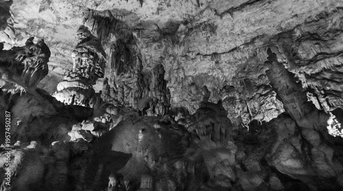 Fotografi Limestone cave interior with stalactites and stalagmites illuminated in undergro