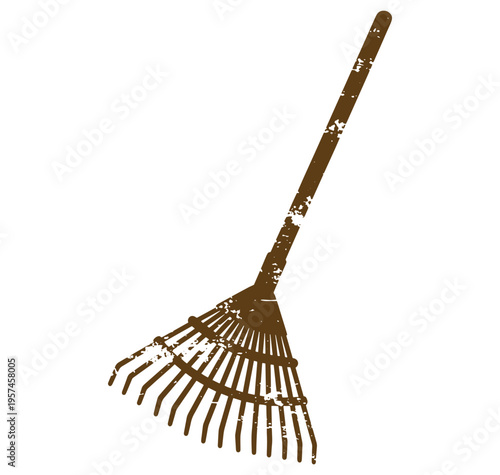 brown rake with long handle and tines for gardening and yard work
