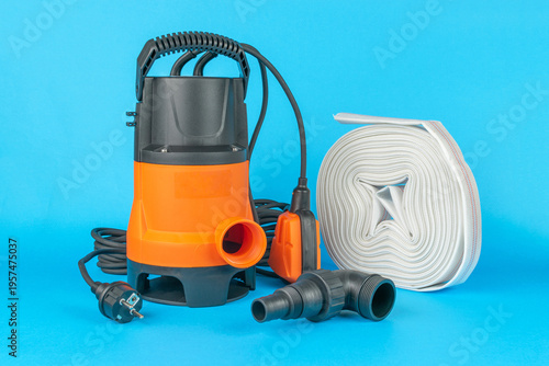 Submersible Water Pump with Accessories on Blue Background