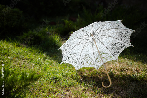 white lace umbrella on green grass