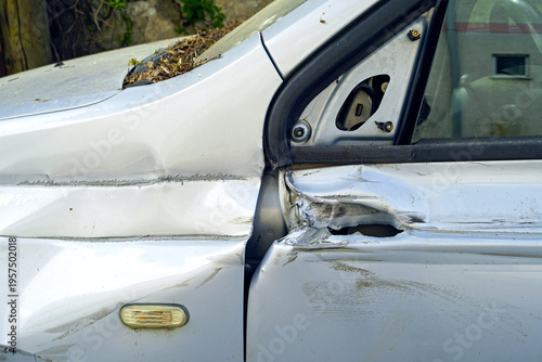 Photos Bent vehicle frame section near door hinge with severe structural distortion in outdoor setting