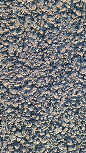 Granular asphalt texture close-up, rough urban surface