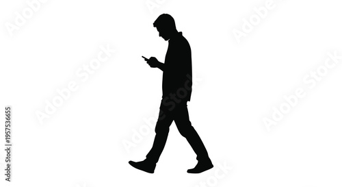 A man walks while looking at his mobile phone captured as a striking black silhouette high quality professional detailed modern elegant