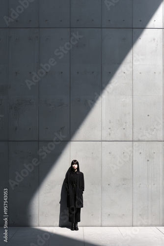 Wallpaper Mural Young Woman in Minimalist Black Overcoat Standing Against Brutalist Concrete Torontodigital.ca