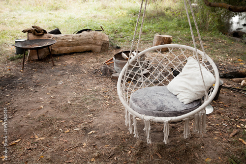 Cozy swing chair in a peaceful outdoor campsite setting during daylight hours