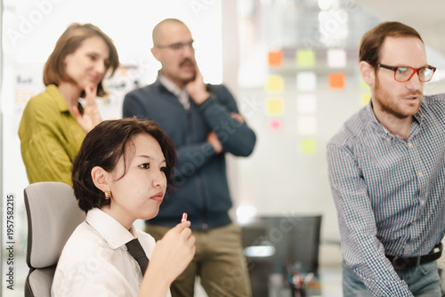 Photos Businesspeople collaborate in a modern workspace, discussing strategies while an
