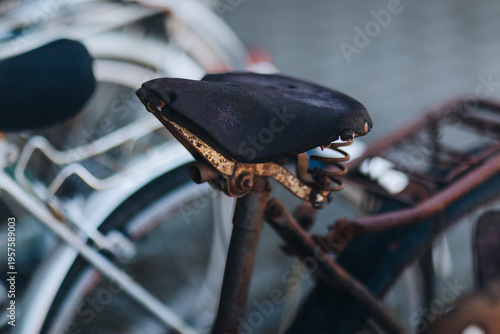 Old bicycle saddle with rusted spring in close-up