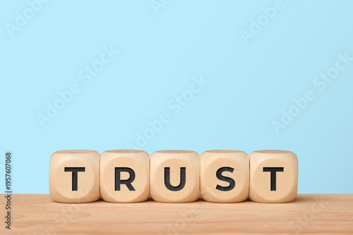 Trust and reliability concept with word trust on blue background