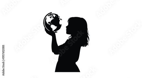 Young girl gazing at a globe in her hands a striking silhouette