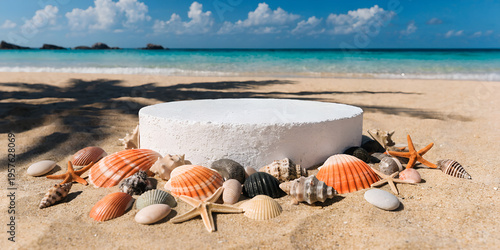A white circular podium rests on a sandy beach surrounded by seashells and starfish, with the ocean and palm leaf shadows in the background