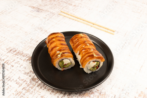 Close sushi rolls with salmon and cream cheese on plate
