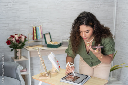 Female jewelry designer managing online small business store