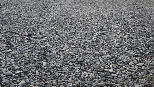 Photography perspective view on washed gravel in gray, laid out on ground Grey rock gravel pebble texture pattern gravel stone background