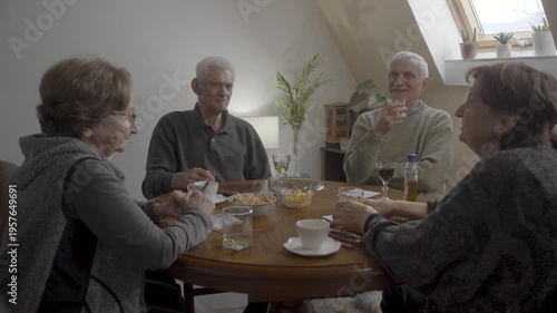 Ederly men and women talking while playing board games