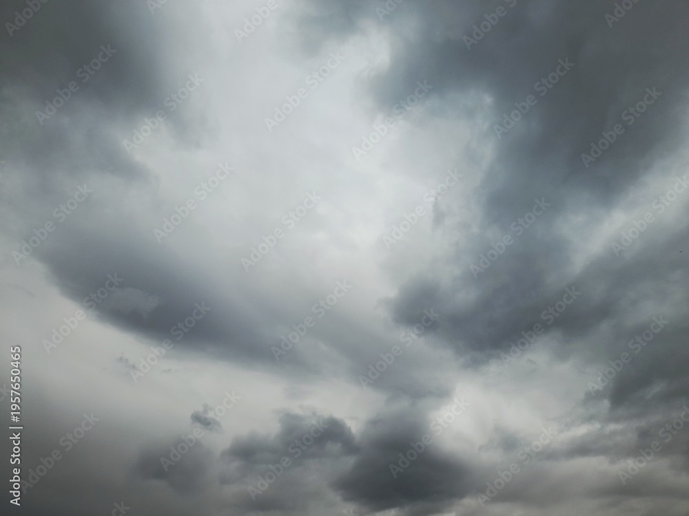 Fototapeta premium Dramatic storm clouds over dark sky, moody grey nimbus background, natural weather phenomenon