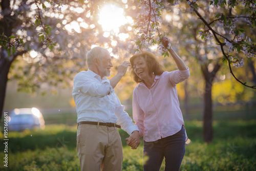 Beautiful senior couple in love on date in spring nature.