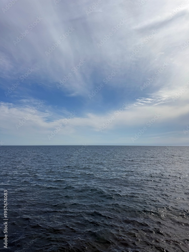 Fototapeta premium Open sea dark blue waters and cloudy sky.