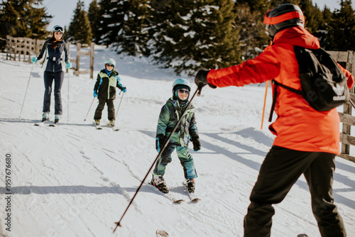 Family enjoys skiing togeth...