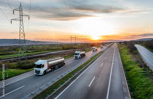 Canvas Print Convoy or Fleet of Tank trucks with oil or gas on a Highway through the rural la