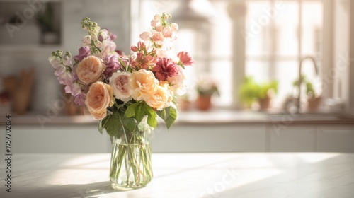 Bouquet of Fresh Flowers in a Glass Vase Sitting on a Kitchen Counter Bathed in Bright Natural Light