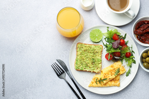 Healthy breakfast with delicious avocado toast served on light table, flat lay. Space for text