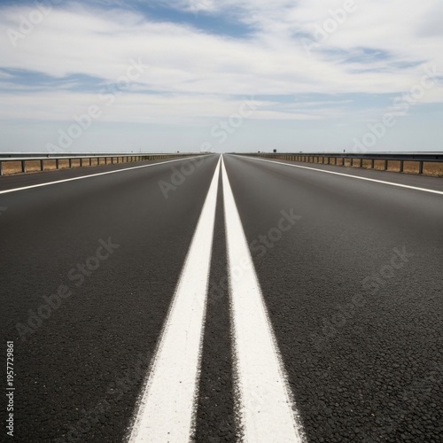 Endless Highway Stretching Towards The Horizon Under A Vast Sky