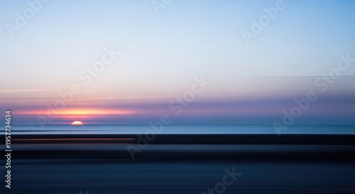 Abstract Sunset Over Ocean Horizon with Blurred Motion and Vibrant Colors.