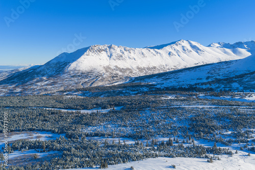 Aerial view of the snowy peak of Flattop Mountain in Anchorage, Alaska.