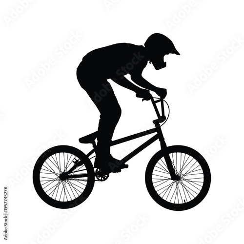 Silhouette of a bmx rider in motion performing an athletic stunt