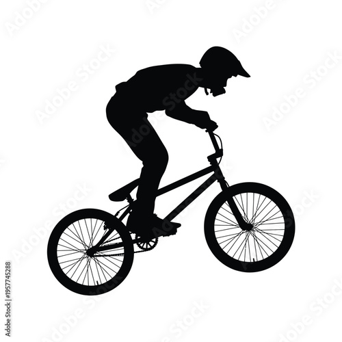 Silhouette of a cyclist performing a trick on a bmx bike